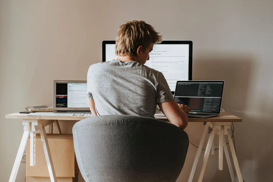 A sleek computer monitor showing web design projects, highlighting creative visuals in a workspace.